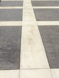 Image: Decorative stripe on cement driveway.