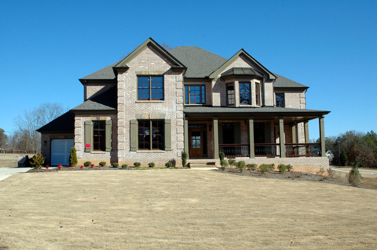 Image: House with large driveway.